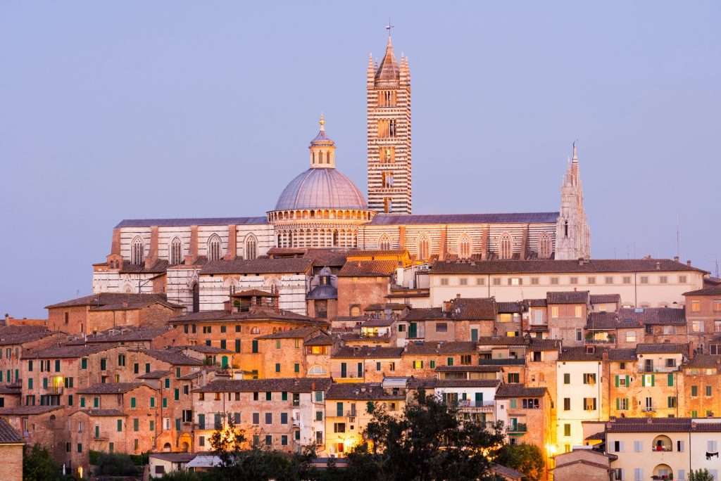 Cityscape view of Siena Cathedral at dusk, Siena, Tuscany, Italy
